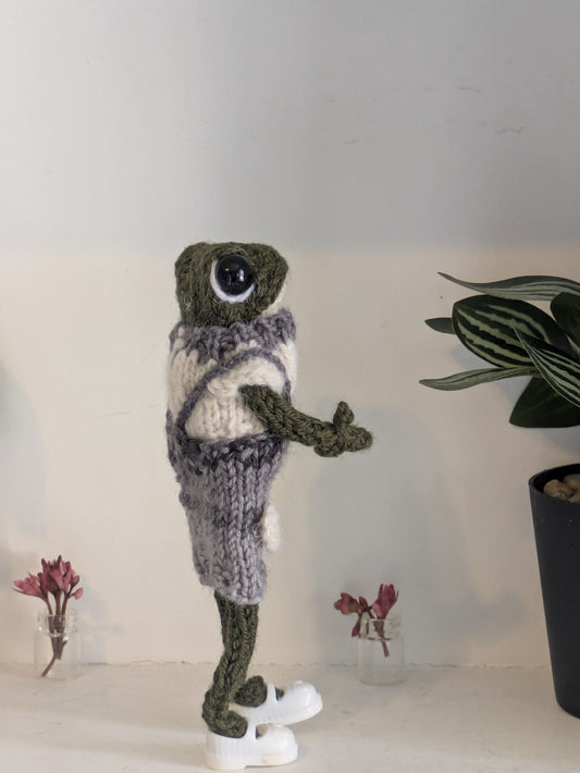 Vue latérale montrant la posture articulée de la grenouille d'art